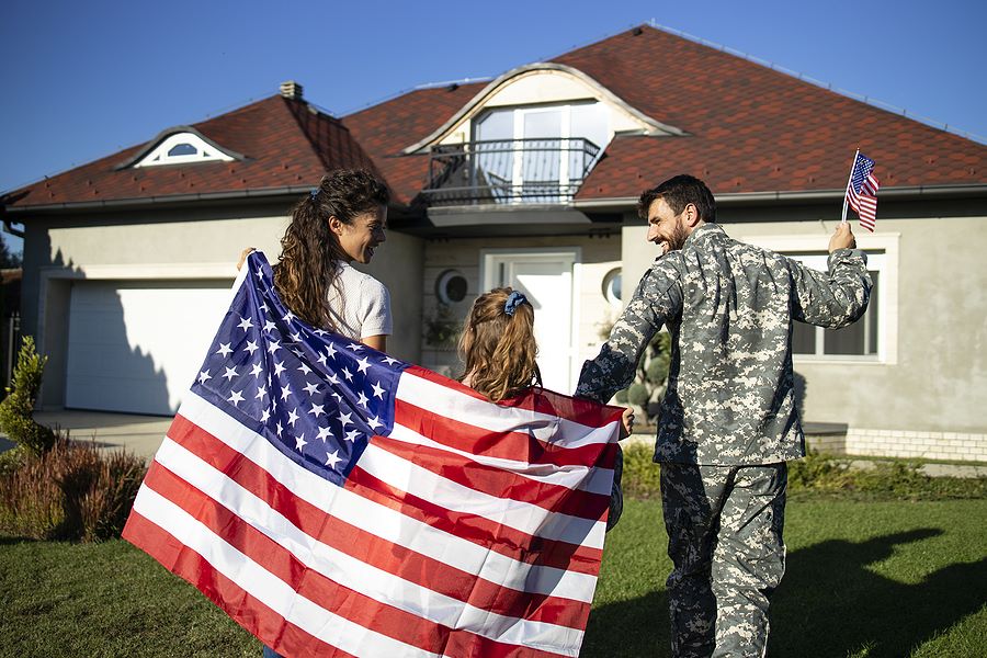 US Military soldier and family happily walking to house